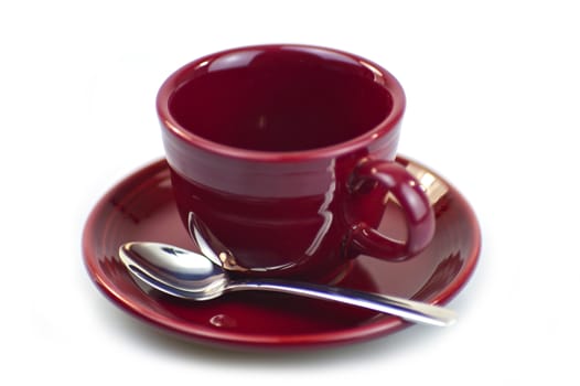 Empty Burgundy Coffee Cup with Chromed Spoon. Isolated White Background.