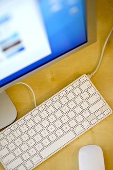 Desktop Computer - Wood Desktop. White Keyboard, Mouse and Large Computer Screen.