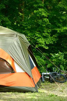 Large Camp Tent and Bikes. Outdoor Theme. Vertical Camp Photo.