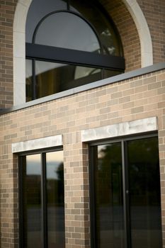 Part of Commercial Building. Brick Walls and Dark Windows.