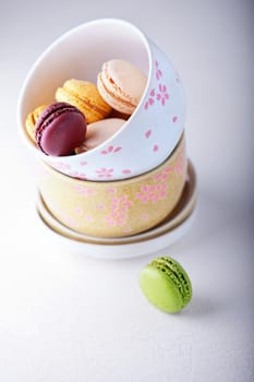 Bowl of colorful almond cookies macaroons on the table