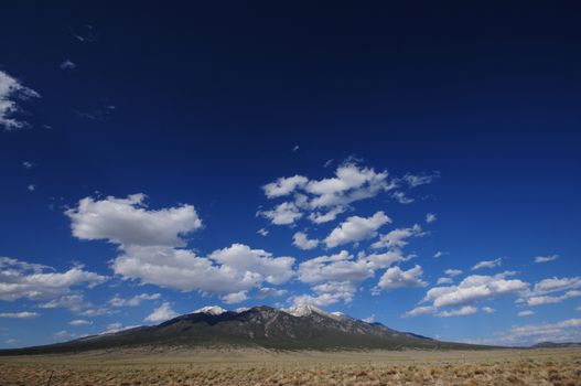 Lonely Mountain - Colorado Rocky Mountains. Dark Blue Sky with Some Small Clouds.