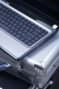 Mobile Office Theme. Laptop Computer with Silver Documents Case. Mobile Office Vertical Photo.