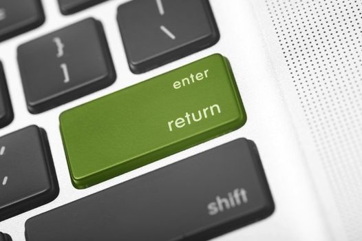 Green Return Laptop Button. Grayscale Keyboard Macro Shot with Green Enter - Return Button.