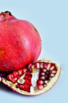 Pomegranate Fruits Vertical Photo. Light Blue Background. Fruits Photo Collection.