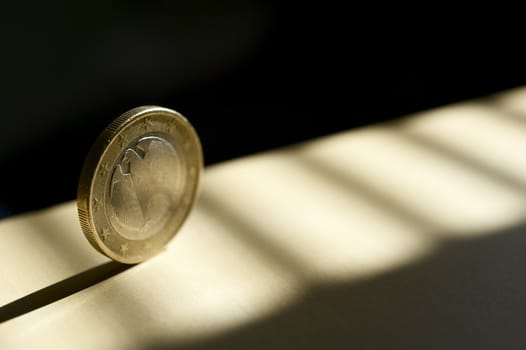 Rolling Euro Coin in the Spot Light. Business Theme Photography.