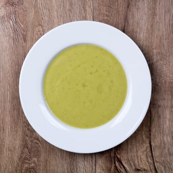 Vegetarian vegetable soup on a wooden table