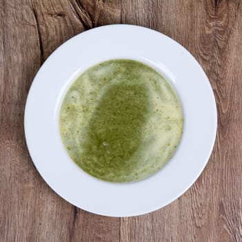 Vegetarian vegetable soup on a wooden table