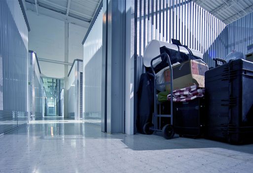 Fully Loaded Storage Unit and Storage Facility - Warehouse Hallway. Climate Controlled Storage Building.
