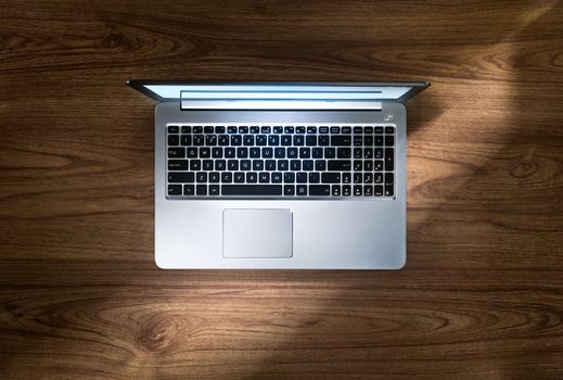 close up view of nice silver laptop on wooden desk top