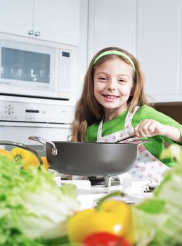 view of young beautiful girl cooking at the kitchen