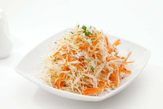 close up view of fresh vegetable salad on white background