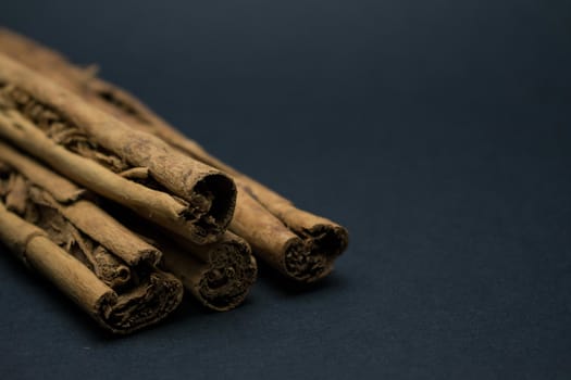 Sticks of cinnamon on a dark background