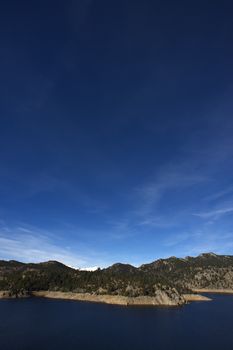 Colorado Clear Sky, Water Reservoir and Mountains. Gross Reservoir - Boulder County, Colorado, USA. Vertical Photography