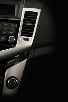 Modern Car Dashboard Vertical Studio Photography. Dark Vehicle Interior with Silver Elements.
