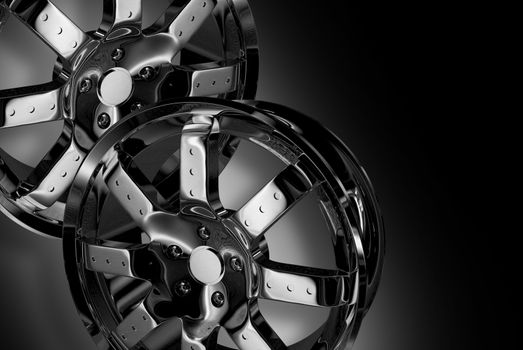 Two Chrome Wheels - Shiny Chromed Alloy Wheels on Dark-Black Background. 