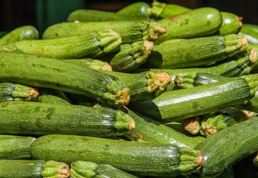 Food background: fresh zucchinis or courgettes from the market