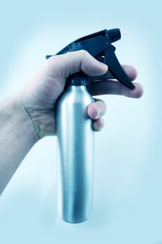 Water Sprayer. Men Hand. Light Blue Background.