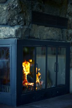 Cozy Fireplace in Mountain Log Home. Vertical Photography.