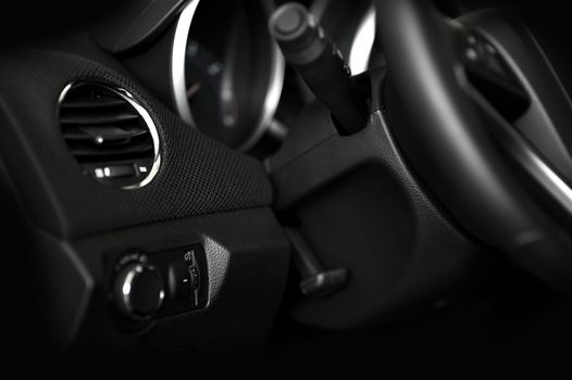 Dark Car Interior - Steering Wheel and Dashboard. Door Side. Modern Vehicle Interior Photo.