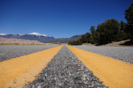 Road to the Dunes. Colorado Highway. Road to the Great Sand Dunes National Park in the Central of the Colorado State. Yellow Road Lines