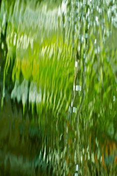 Green Waterfalls - Water Background. Flowing Green Water. Vertical Photo