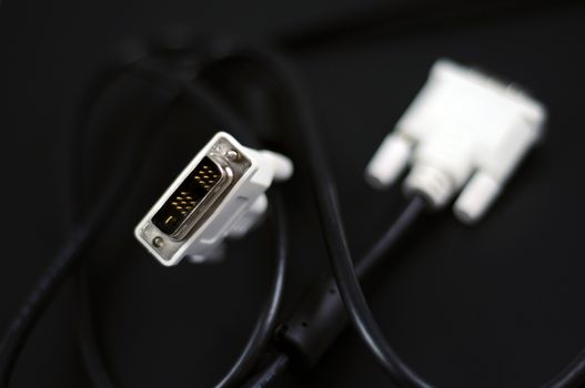 White DVI-D Dual Link Digital Monitor Cable on Solid Black Background. Technology Photo Collection.