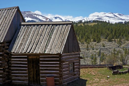 Vintage Home in Central Colorado Summit County. Old Wood Logs Home and Rocky Mountains in the Background.