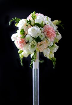 Decorative Plastic Flowers Bouquet on Dark Solid Background. Vertical Photo.