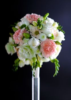 Wedding Decoration: Flowers Bouquet on Dark Solid Background. Vertical Studio Photo.