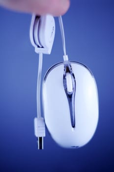 White Wired PC Mouse with USB Cable. Dark Blue Background. 