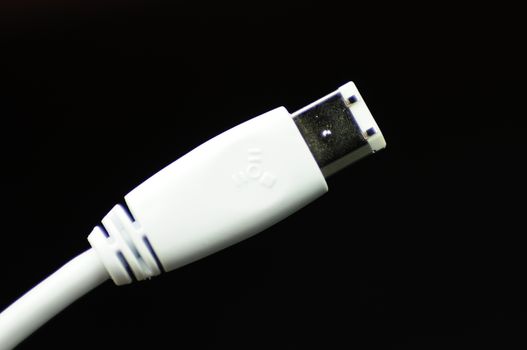 White Firewire Plug / Cable on Solid Black Background.