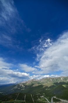 Colorado Blue.  Dark Blue Colorado Sky in Vertical Photography. Rocky Mountains - Summer. Cloudy Sky.