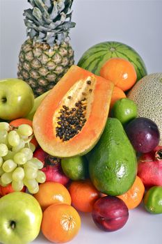 Fruits Pile. Vertical Photo of Many Types of Fruits Like Pineapple, Papaya, Grapes, Apples, Plums and More. Fruits Photo Collection.
