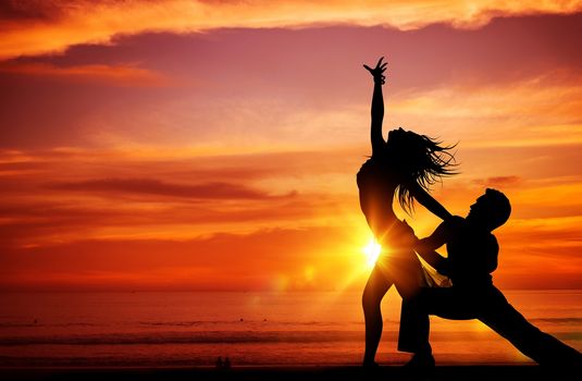 Dancing Young Couples on the Beach at Sunset. 