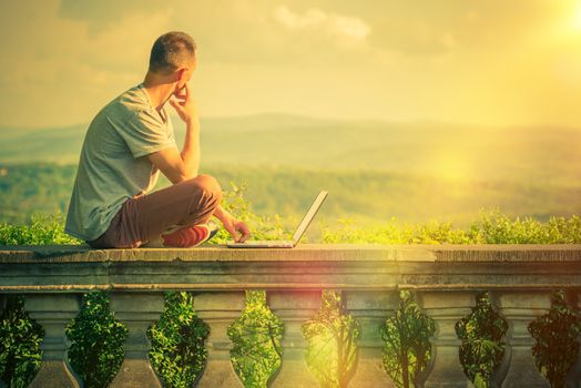 Creative Outdoor Works. Creative Entrepreneur with Laptop Working at His Favorite Outdoor Place with Scenic Panoramic View. 