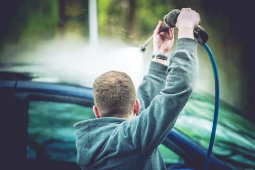 Manual Car Washing. Vehicle Roof Wash by High Pressured Water. 