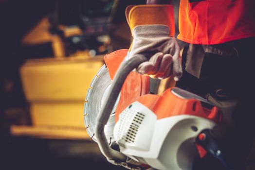 Stone Cutter Works. Construction Worker with heavy Duty Cutter. 