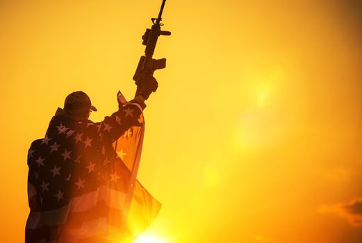The American Victory. Army Troop with Assault Rifle Covered by American Flag. American Patriot
