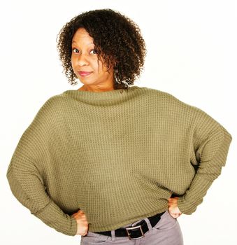 Confident adult African-American woman in green sweater over white background
