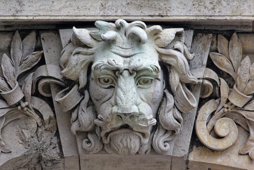 Castle building is decorated with carved stone face.