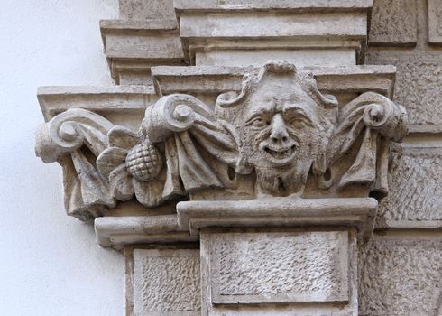 Castle building is decorated with carved stone face.