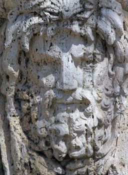 Castle building is decorated with carved stone face.