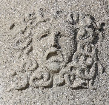 Castle building is decorated with carved stone face.