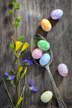 Easter wooden table setting with eggs and flowers