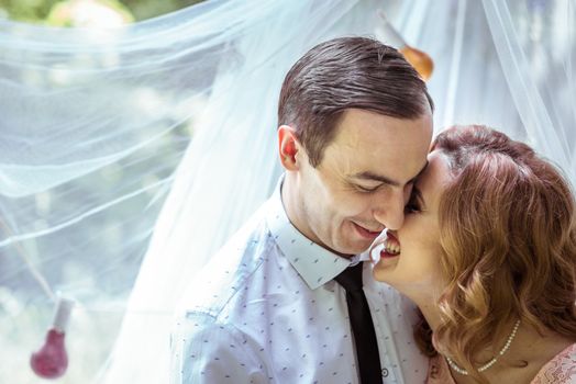 Close up portrait of couple. Smiling man and woman embracing in Lviv, Ukraine.