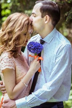 Close up portrait of couple. Man kissing a woman in the forehead in Lviv, Ukraine.