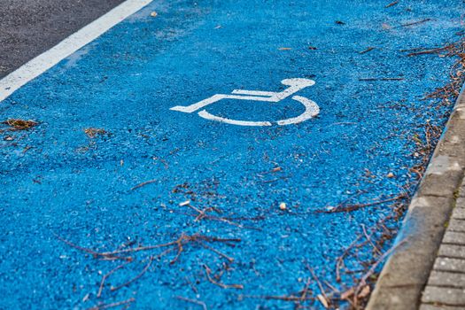 disabled sign painted on asphalt