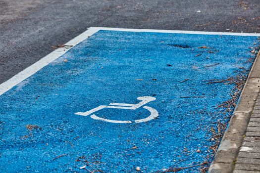 disabled sign painted on asphalt