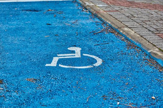 disabled sign painted on asphalt